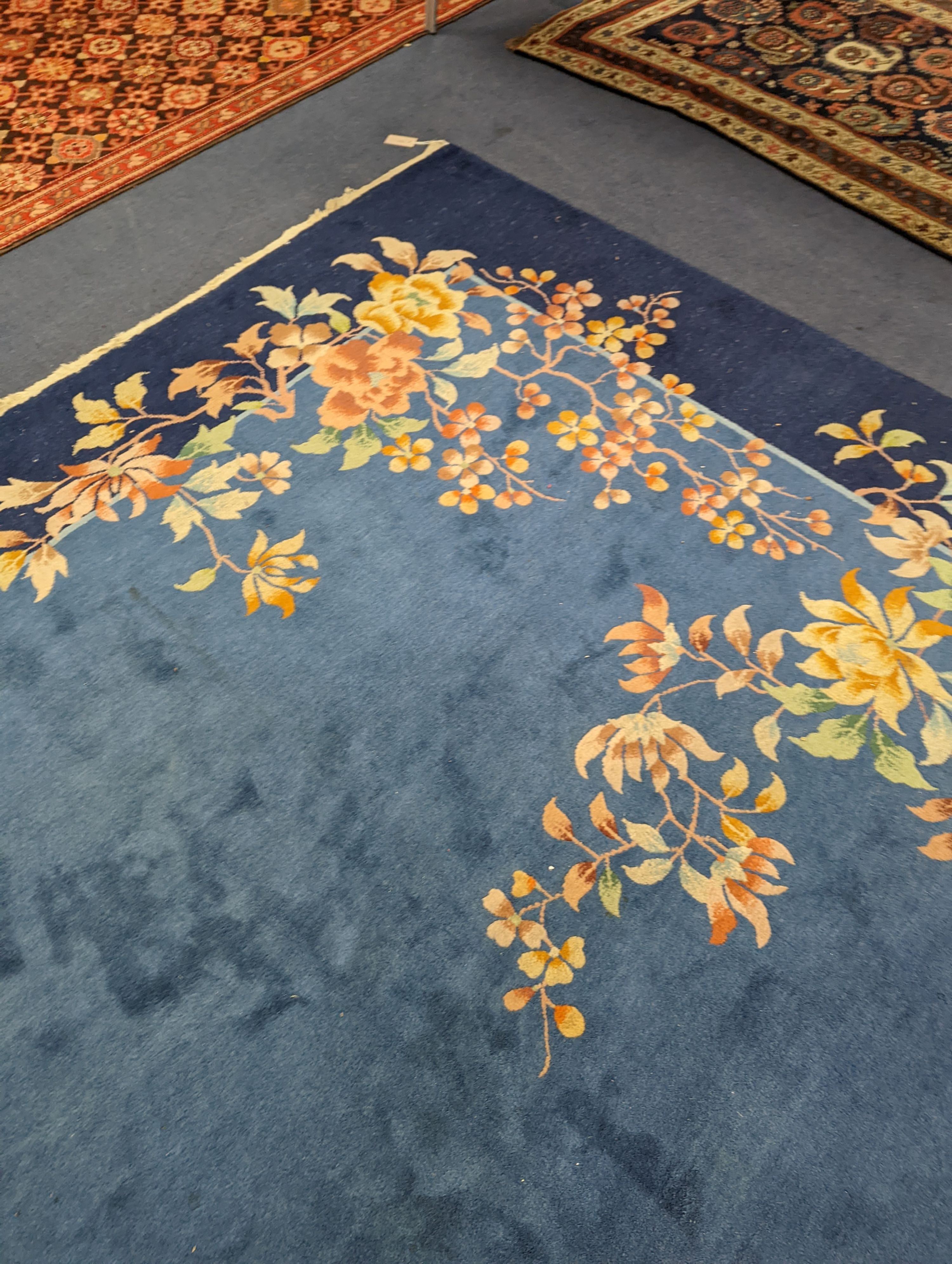 An early 20th century Art Deco Chinese blue ground floral carpet, 400 x 310cm